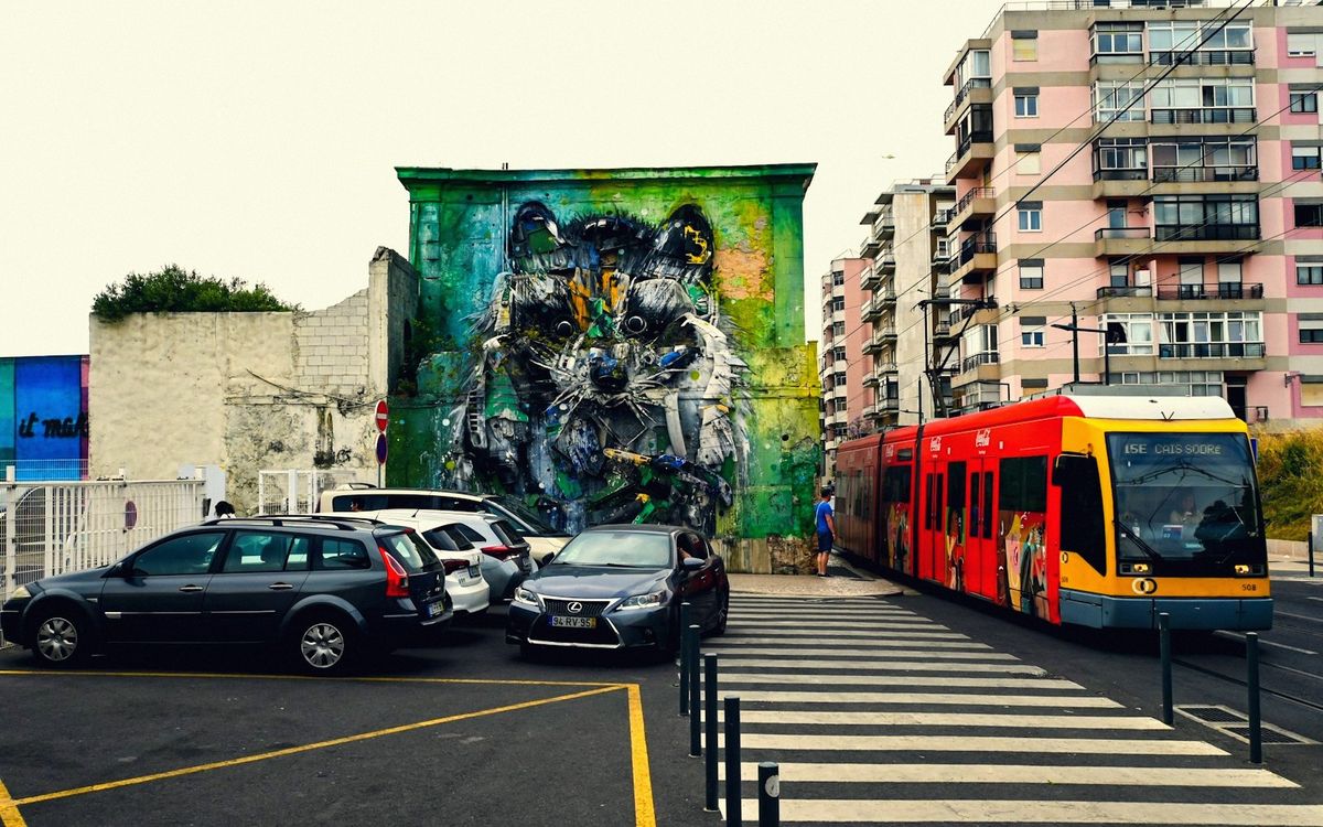 Close-up of the green line painted on Nantes pavement curving toward a distant installation